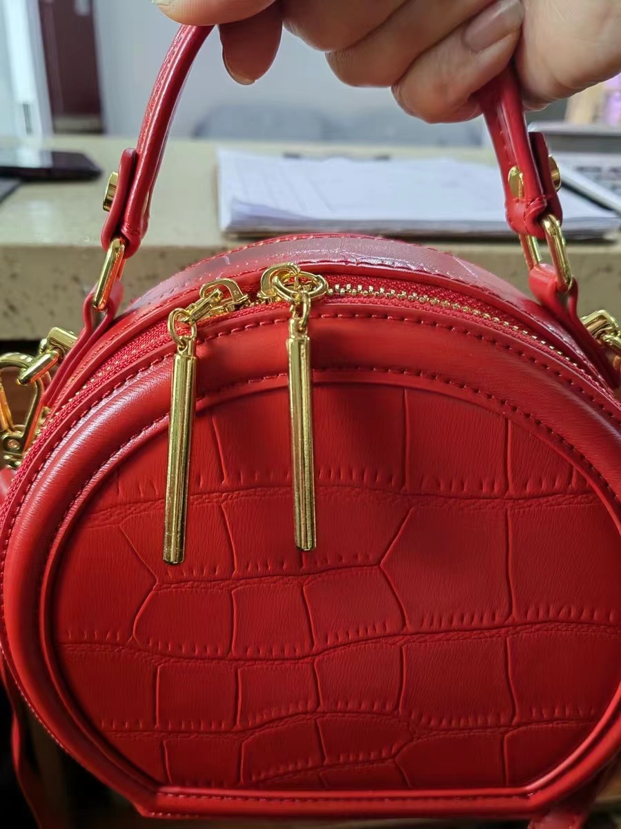 Women's Stone Grain Round Crossbody Handbag in Red photo review