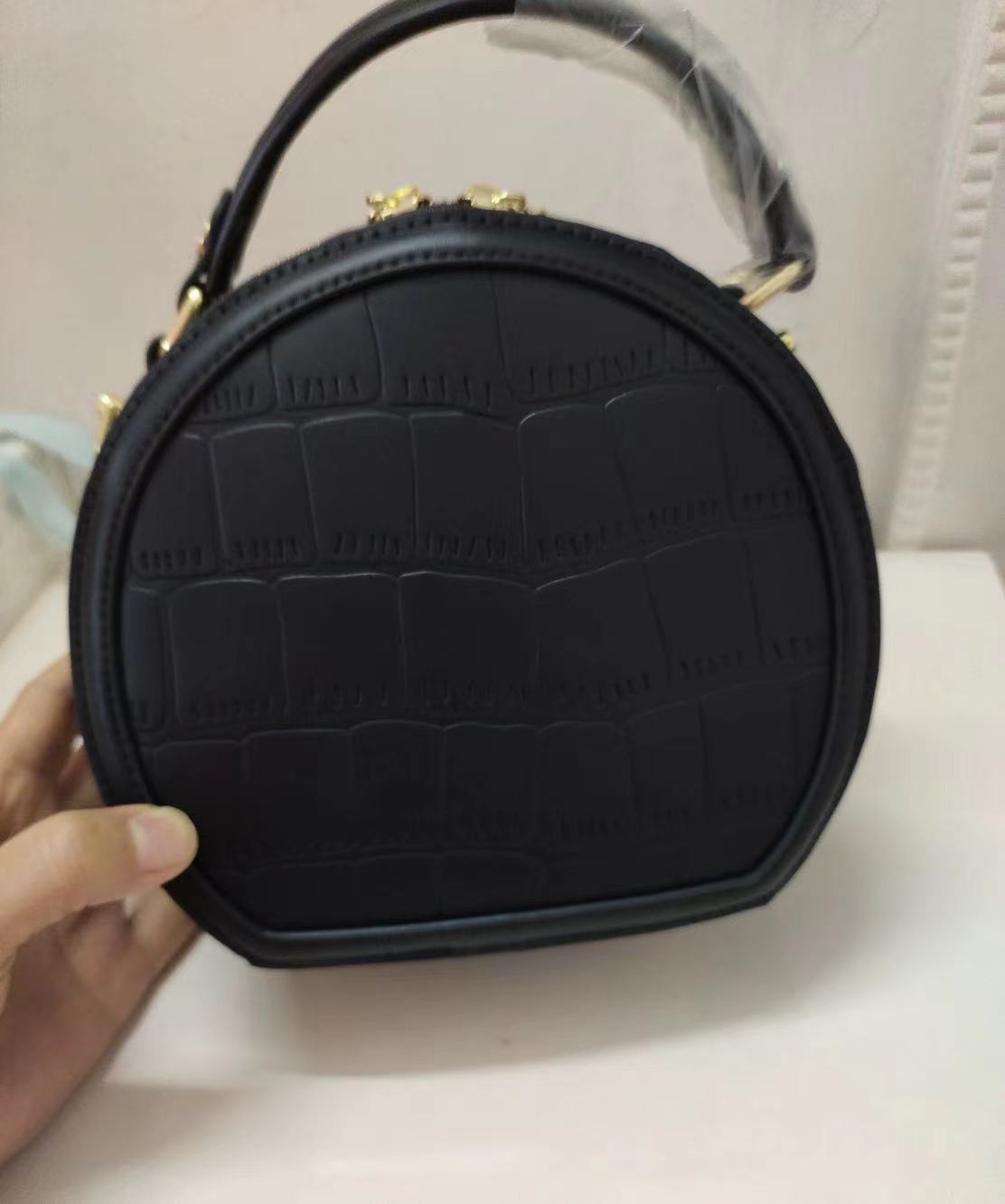 Women's Stone Grain Round Crossbody Handbag in Black photo review