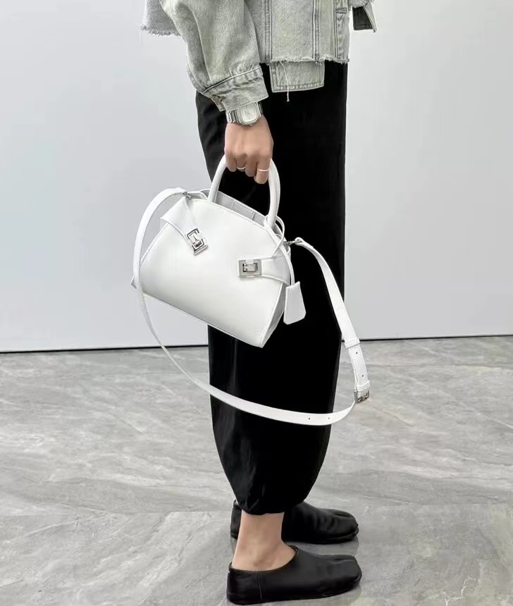 Women's Genuine Leather Oval Minimalist Lock Zipper Crossbody Handbags photo review